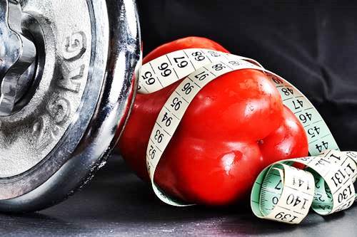dumbbell, red pepper and tape measure: diet and exercise to lose weight