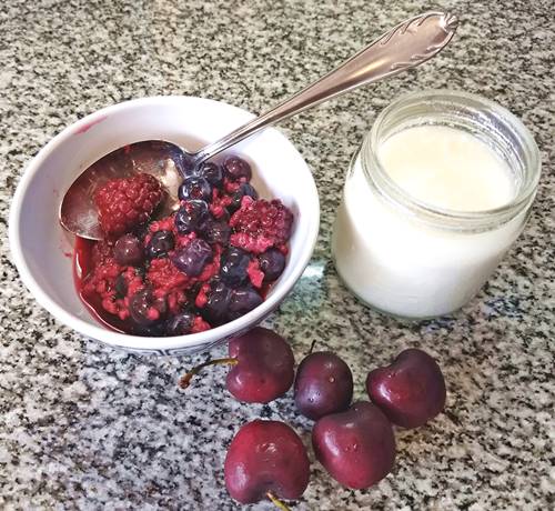 plain yogurt, berries, and cherries for a natural and healthy breakfast