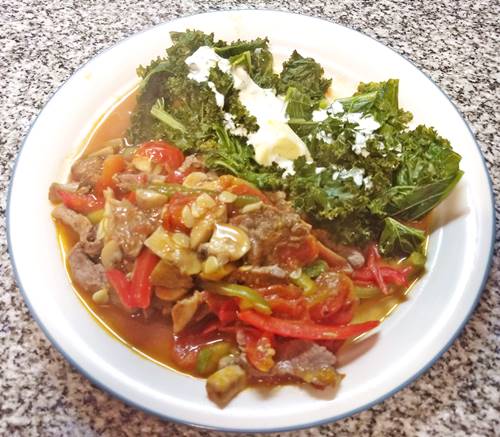 Beef strips with steamed kale & cream and a veggie wok on a plate