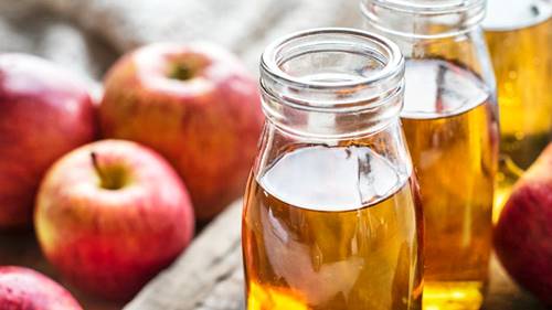 apples and bottles of apple cider vinegar